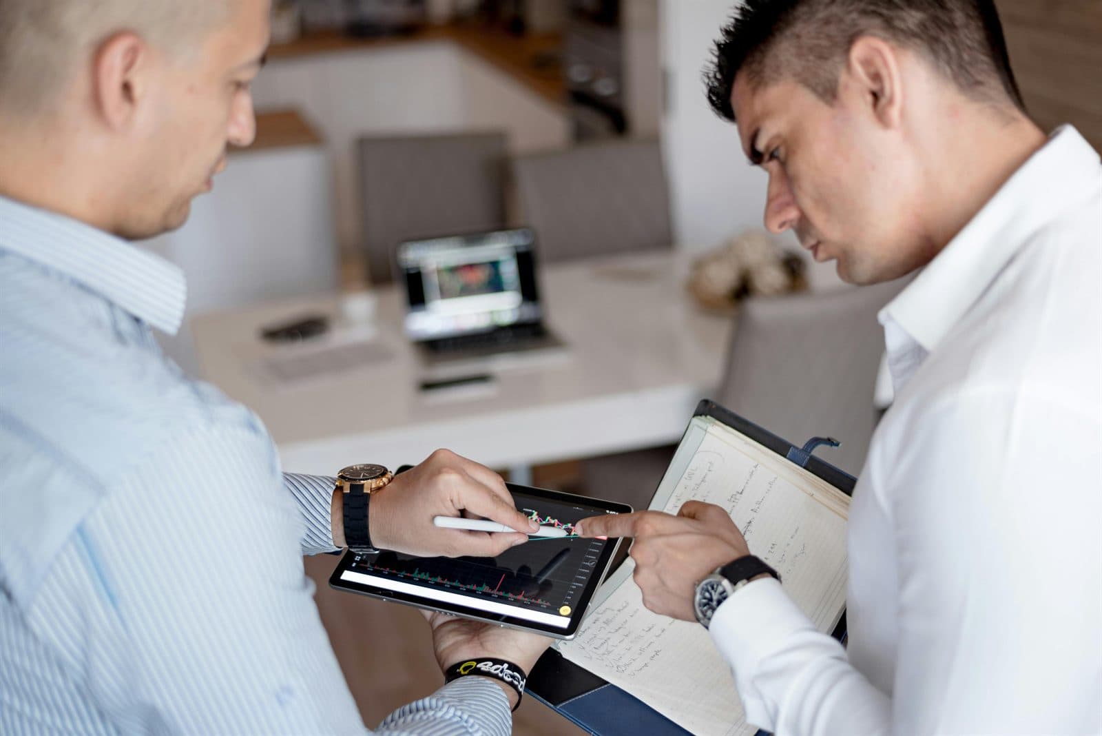 Professionals reviewing financial analysis on a tablet